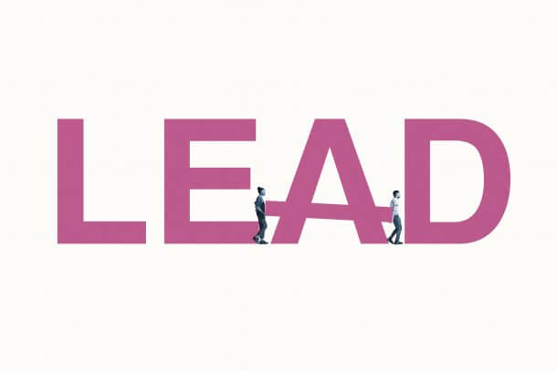 Full length side view of young man and woman building LEAD word against white background