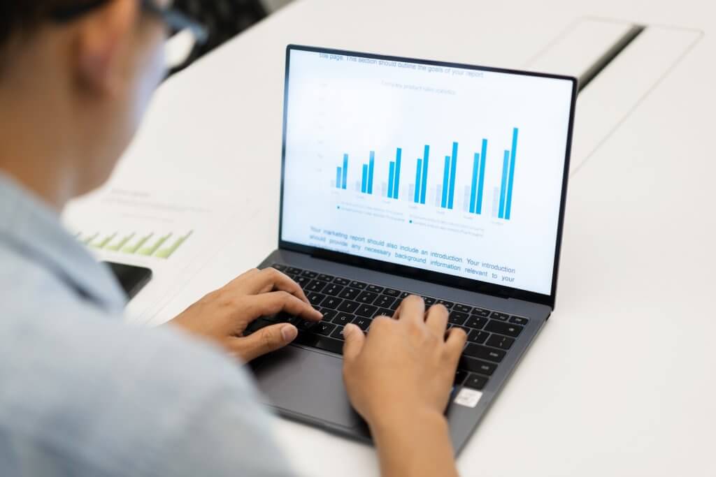 man reading financial report in laptop