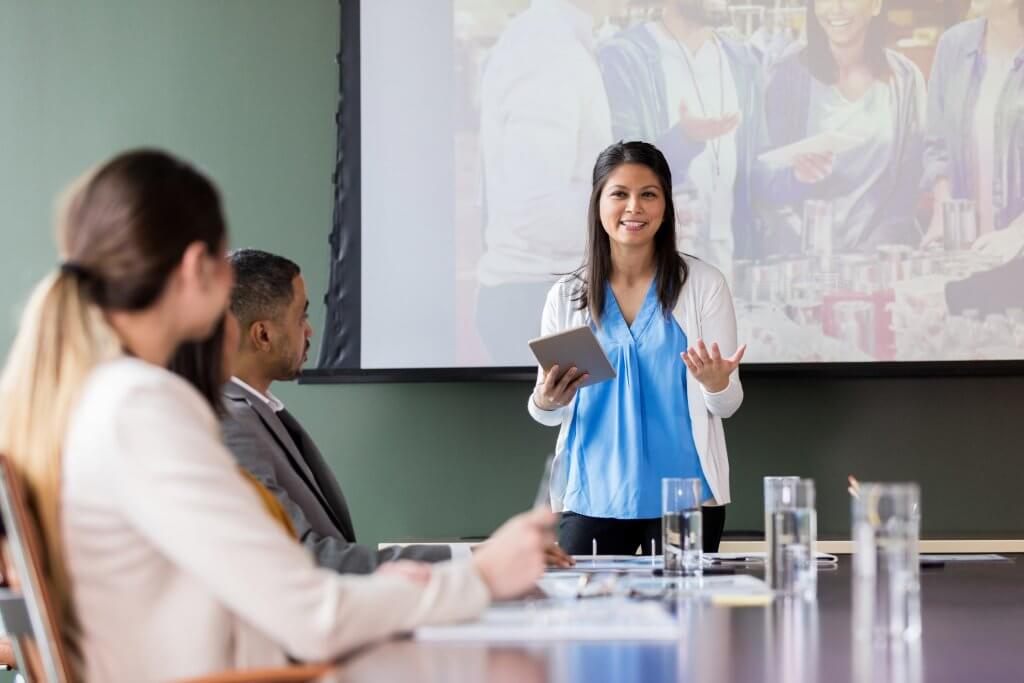 A women presenting nonprofit marketing ideas to a group of people.