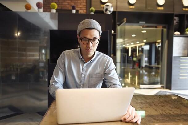 Young Asian freelancer working on a laptop