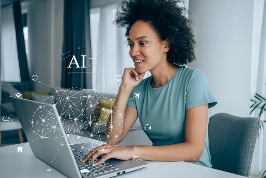 Happy young african-american woman using laptop at home. Human brain and artificial intelligence concept.