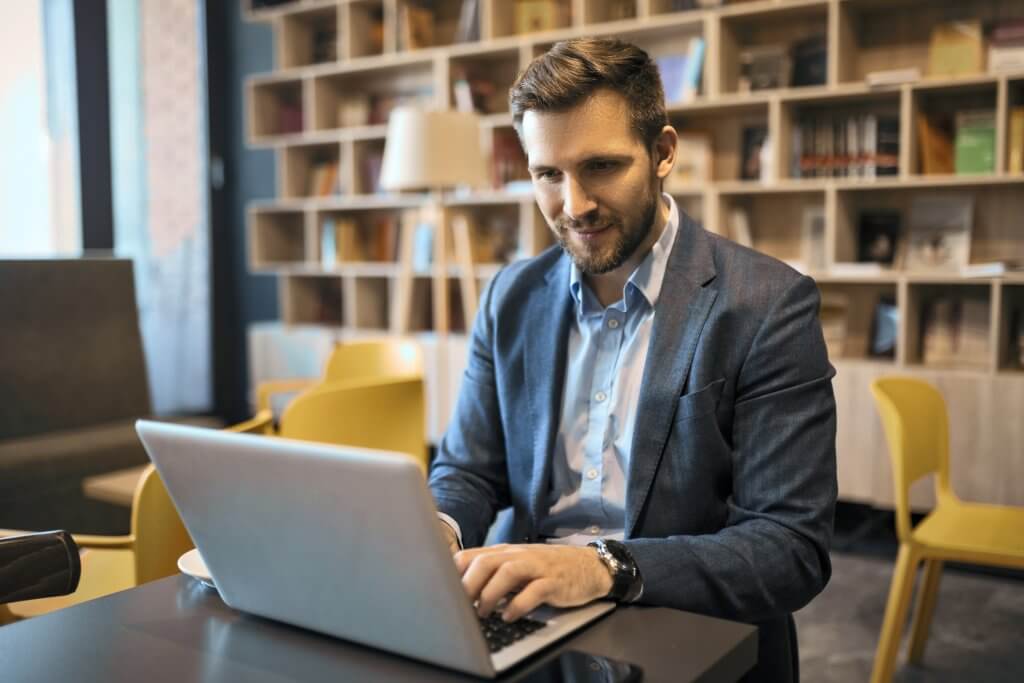 Happy businessman using laptop