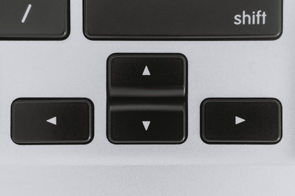 A picture close up of computer keyboard arrow keys.