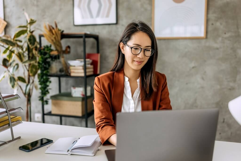 Well dressed beautiful mid adult businesswoman working from home office