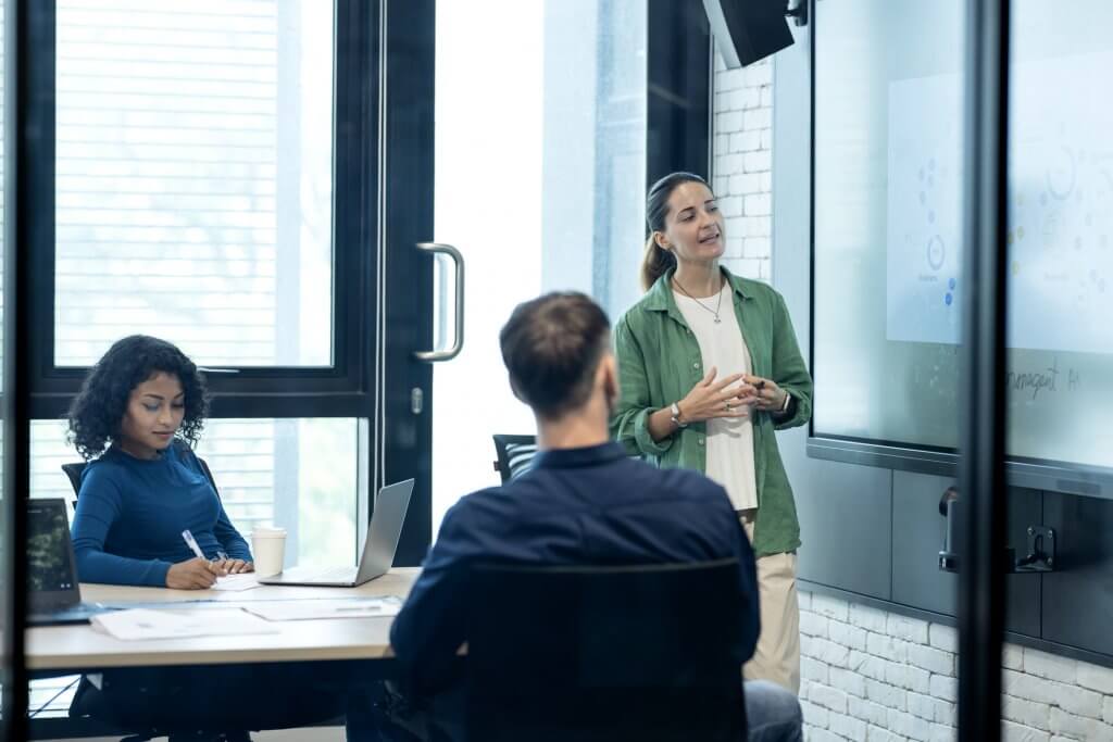 Use the Business Performance Management tool to Identify Market Trends and Demands. Business development manager on a performance review meeting with their team in a modern business office.